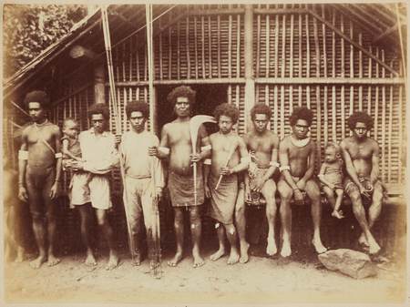 Men holding clubs and curios at Saa
