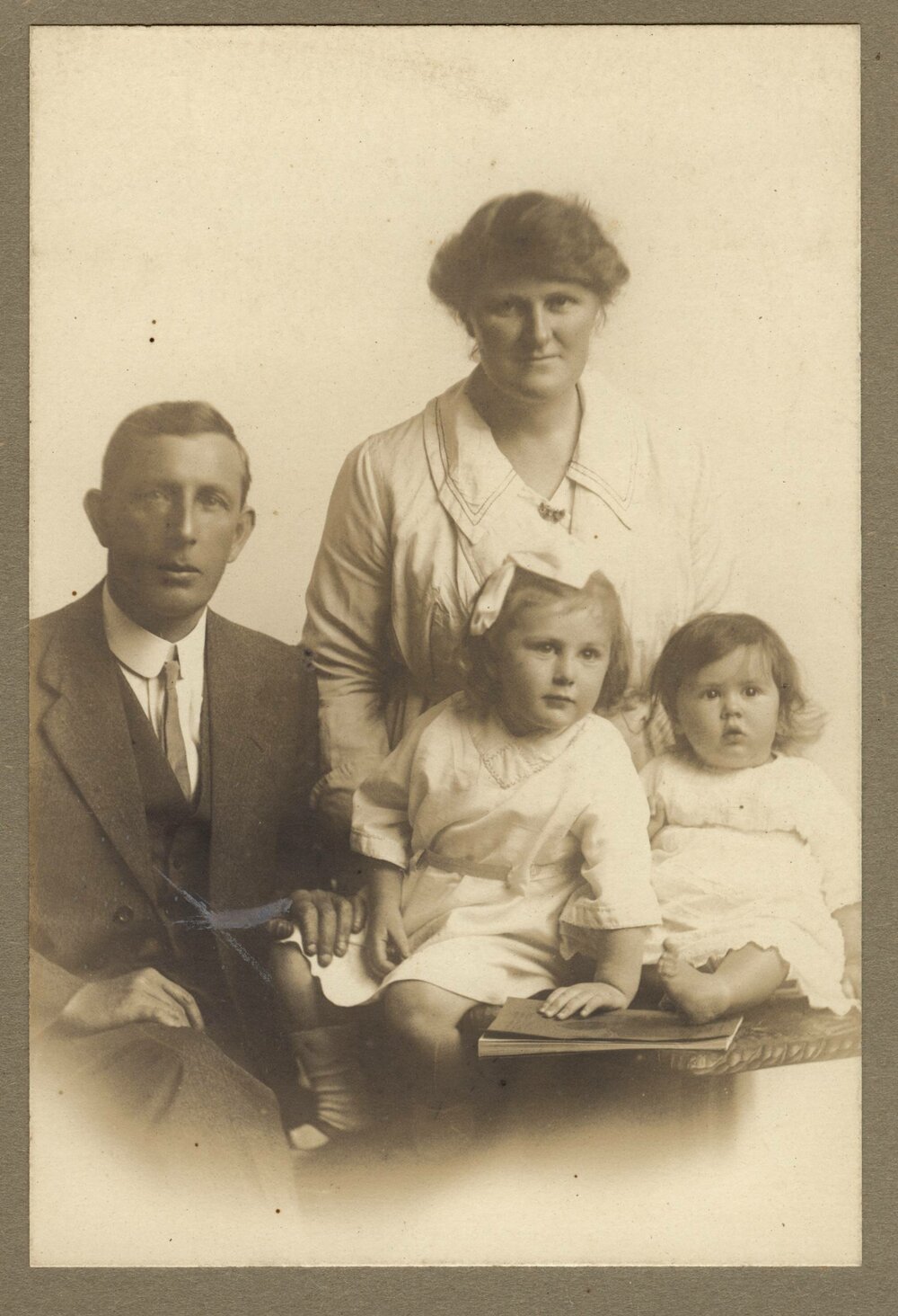 Formal family  portrait of parents with two young children
