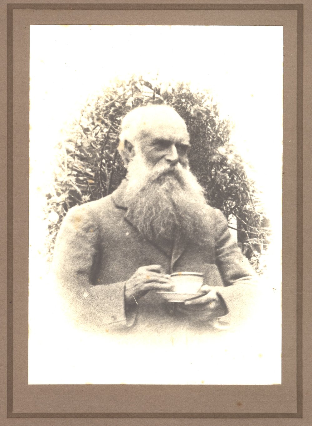 Portrait of a man, probably John Kinder, holding a cup of tea