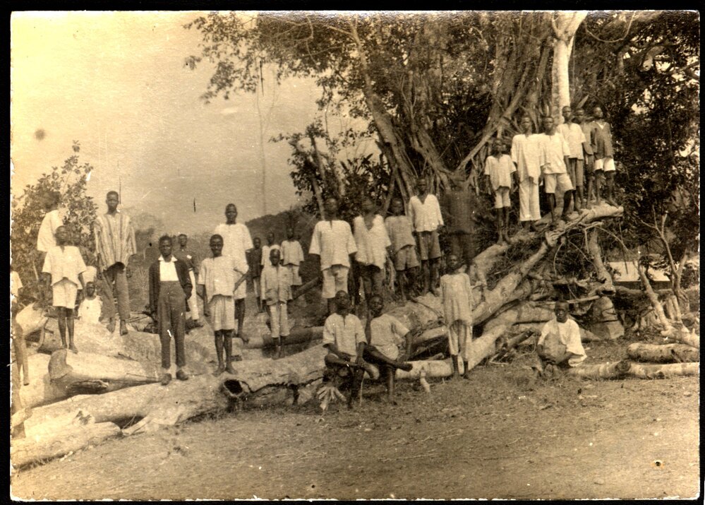 Owo mission, West Africa School boys on timber stack