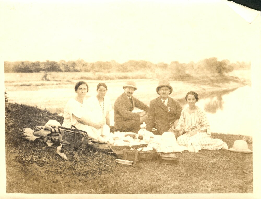 Group of European missionaries at a picnic, probably including Vivienne Opie