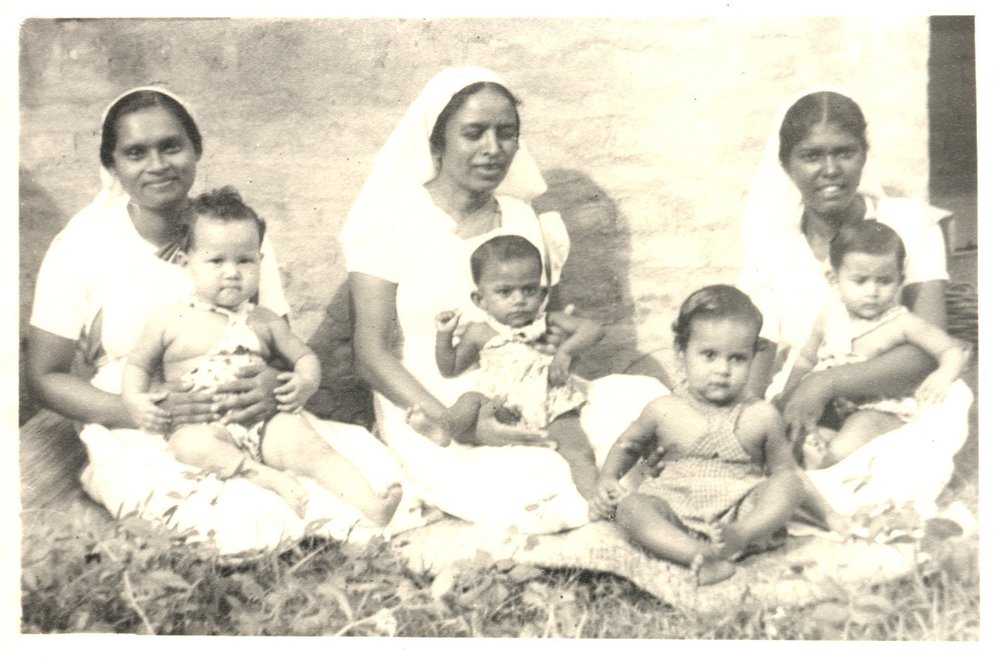 Three Indian nurses with children