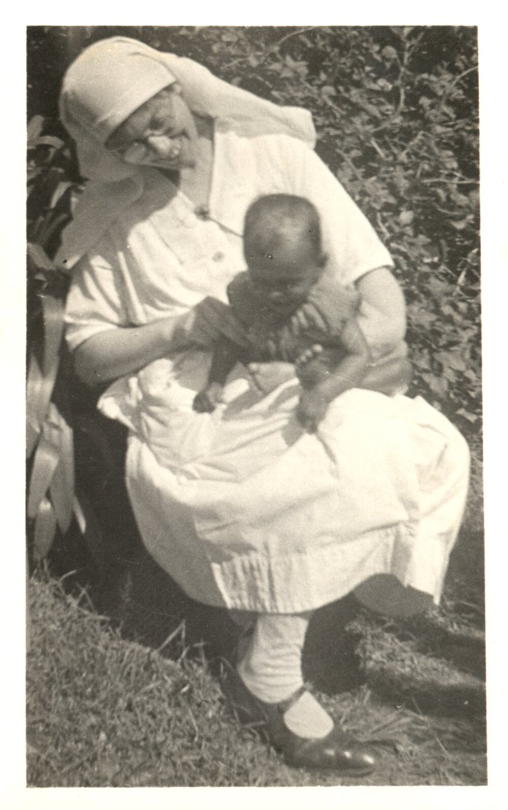 Woman holding a baby. 