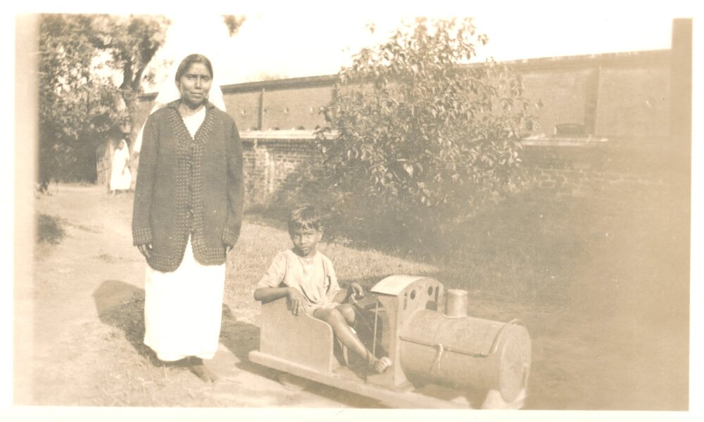 Woman and boy in play train. 