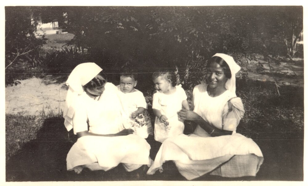 Two women with two small children. 