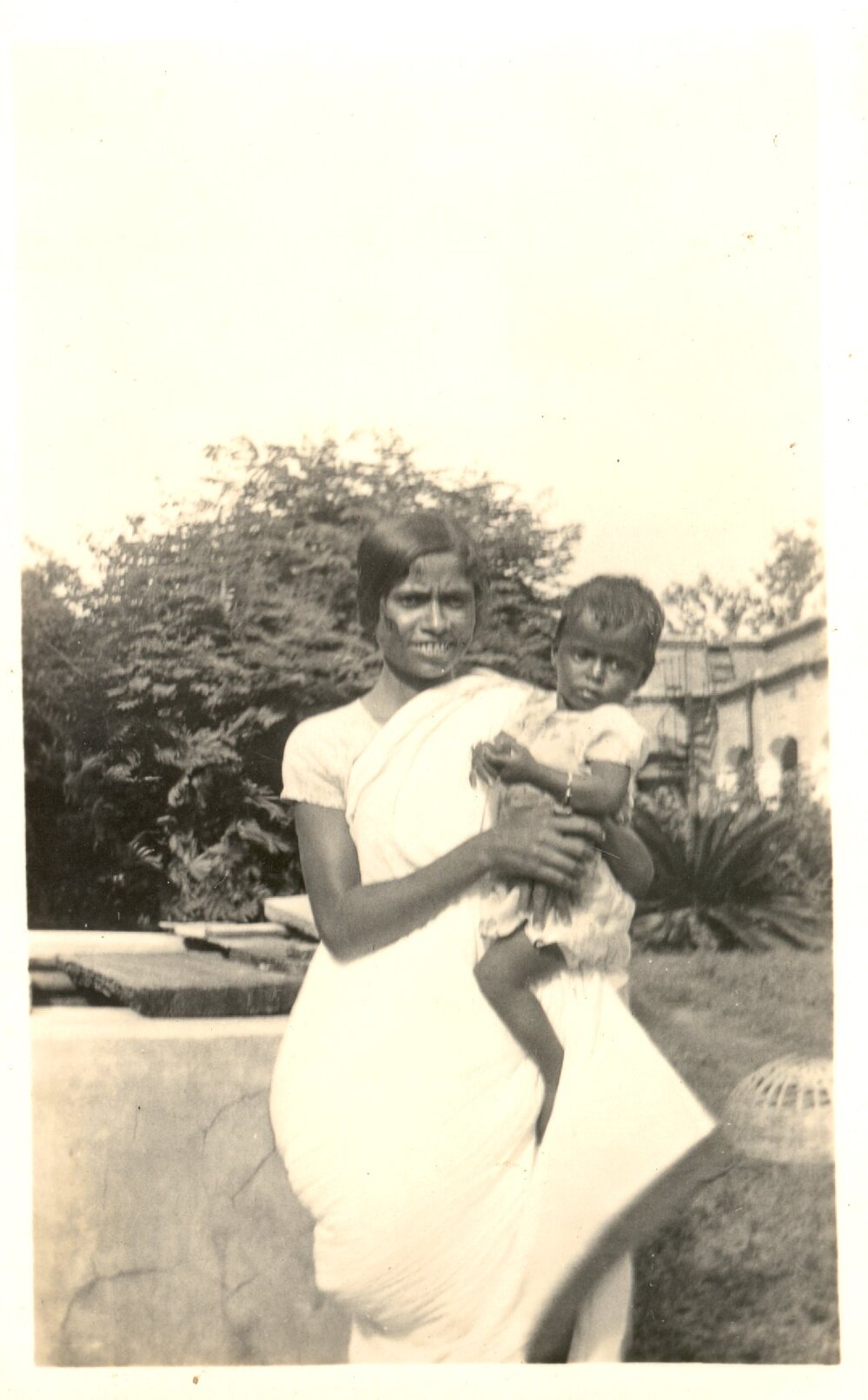 Indian woman holding a small girl. 