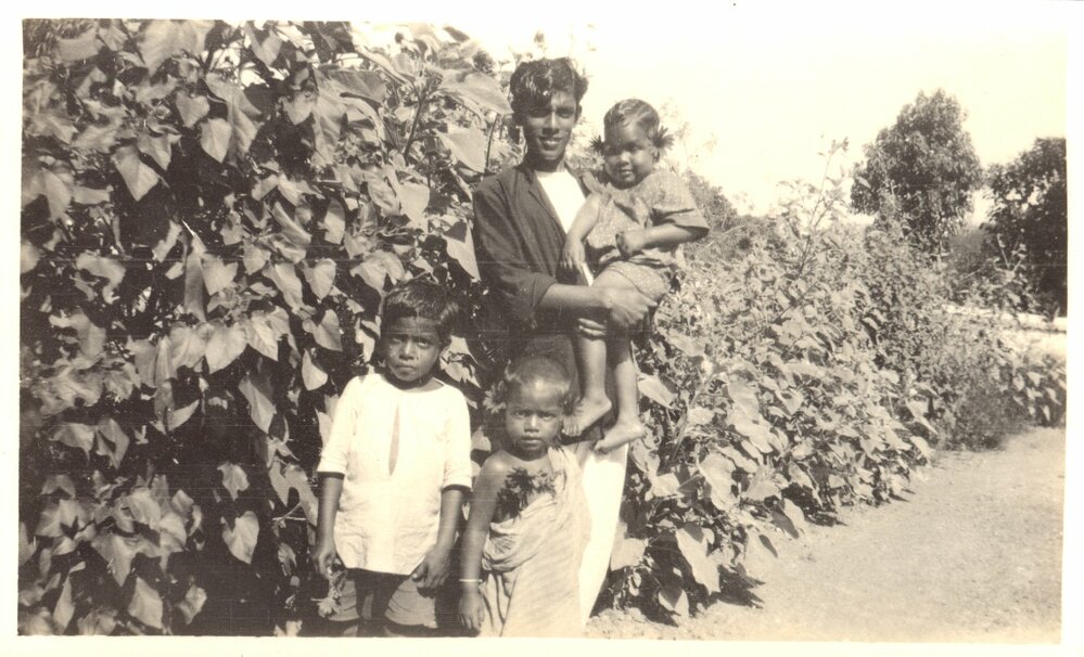 Young man with three young children. 