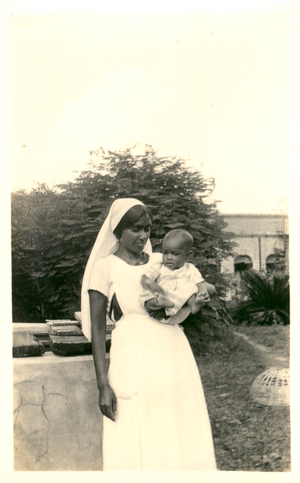 Indian woman holding a small girl. 