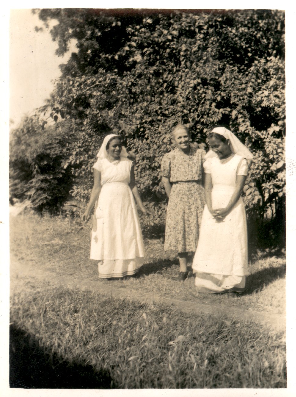 Three women on a oath outside. 