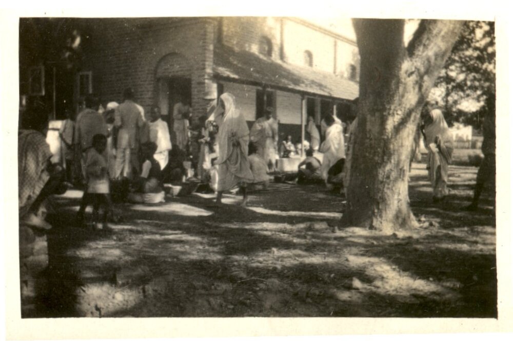 Group of people outside a building. 