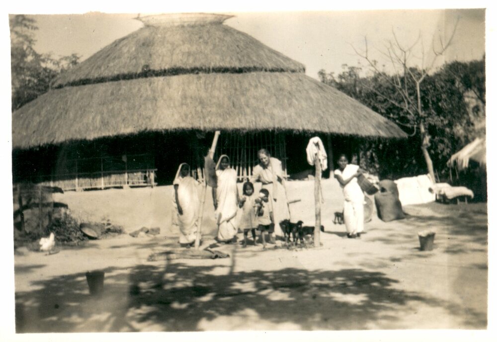 People outside a hut. 