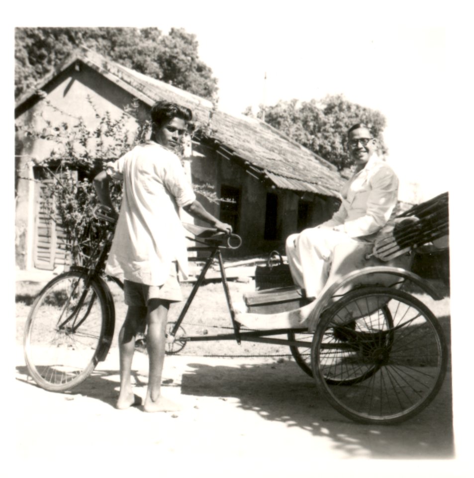 Two men on a bike cart. 