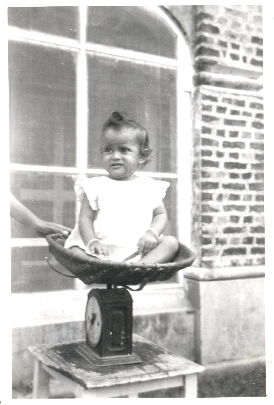 Baby sitting on some scales