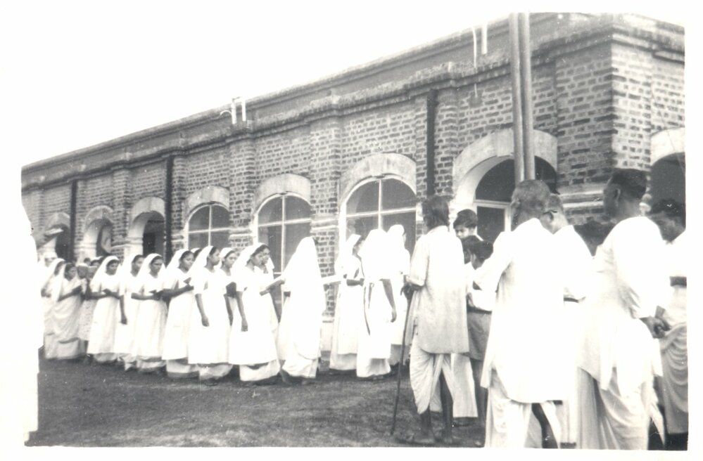 Day of the Blessing. Group of people filing into building. 