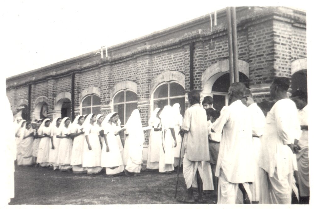 Day of the Blessing. Group of people filing into building. 