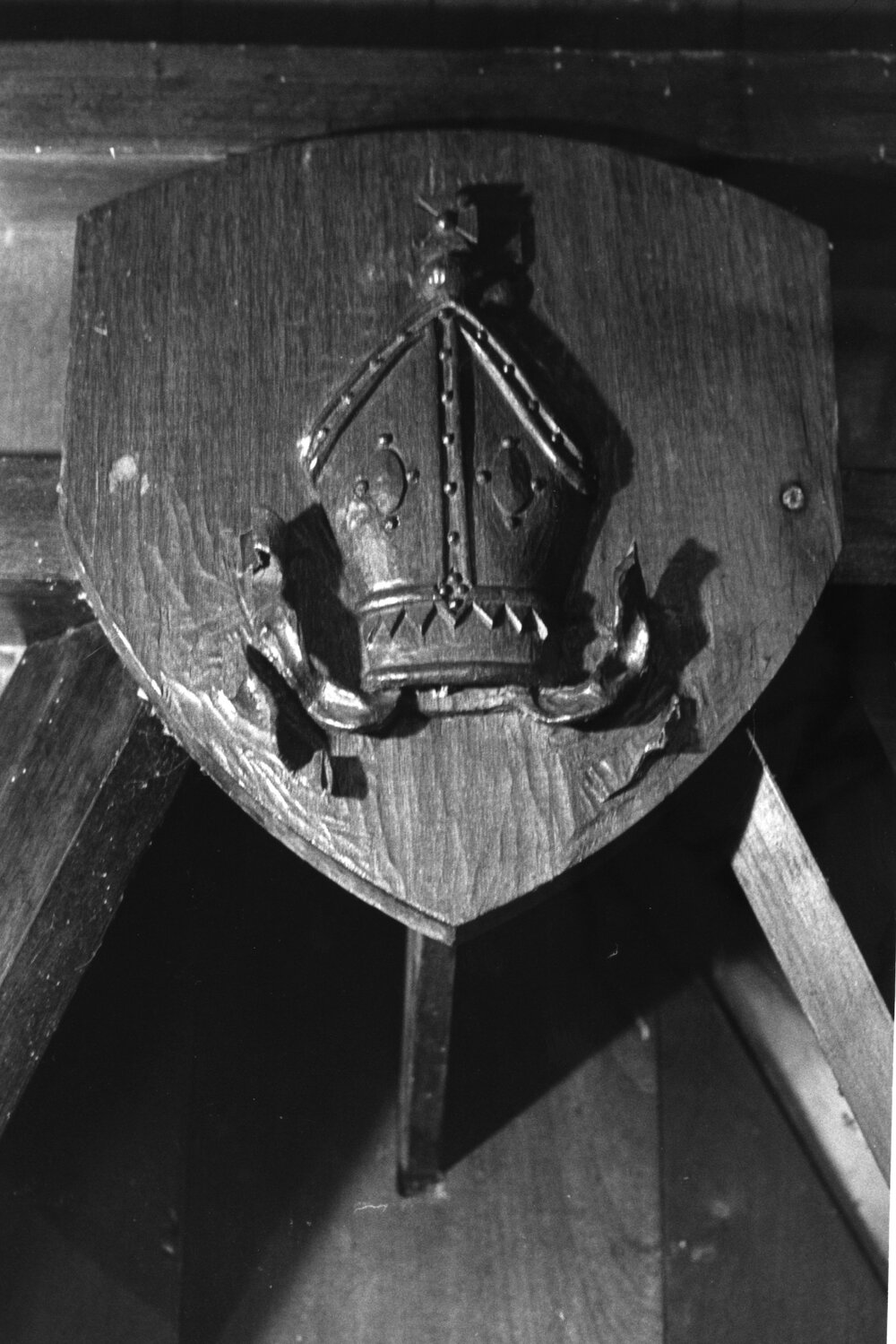 St John's College chapel interior woodenshield showing a bishop's mitre