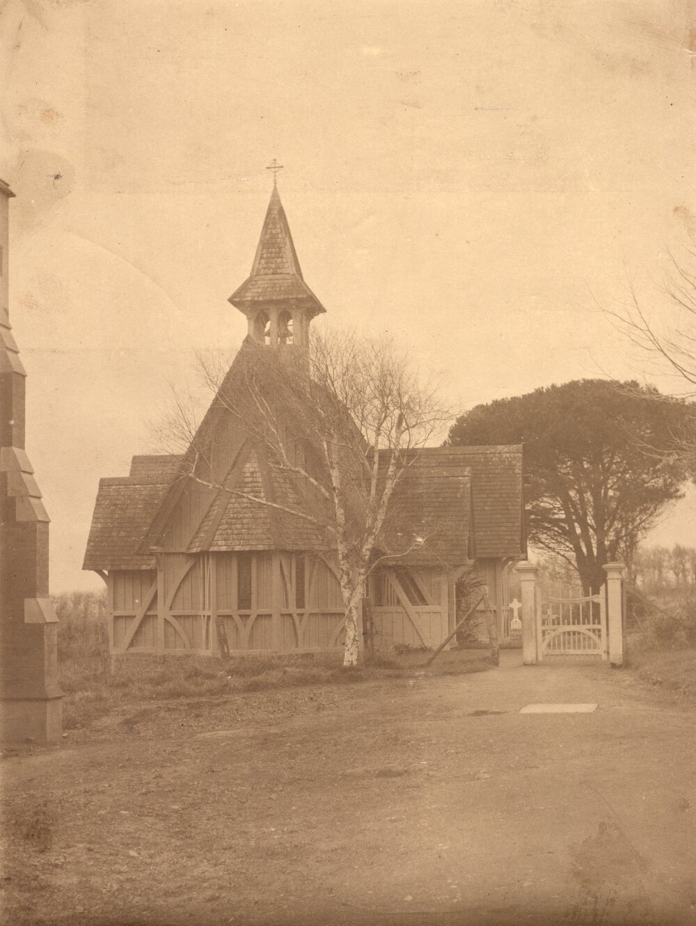 St John's College chapel from the west, showing painted wooden gate, with edge of the Patteson Wing.
