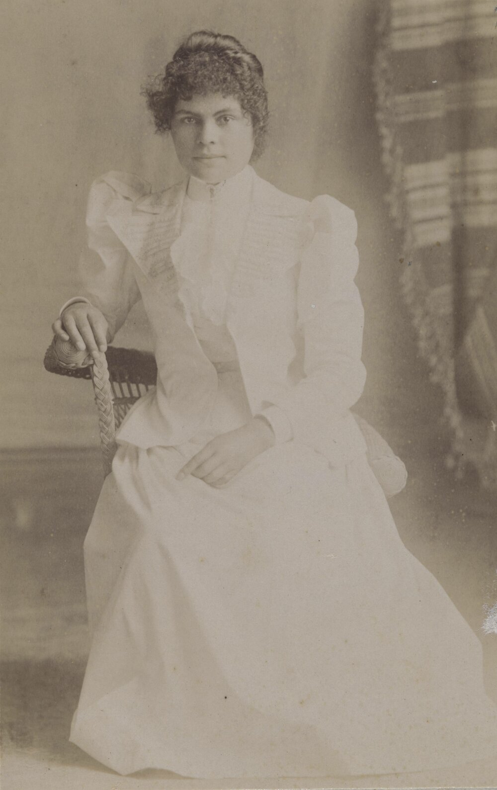 Young woman wearing white dress and jacket