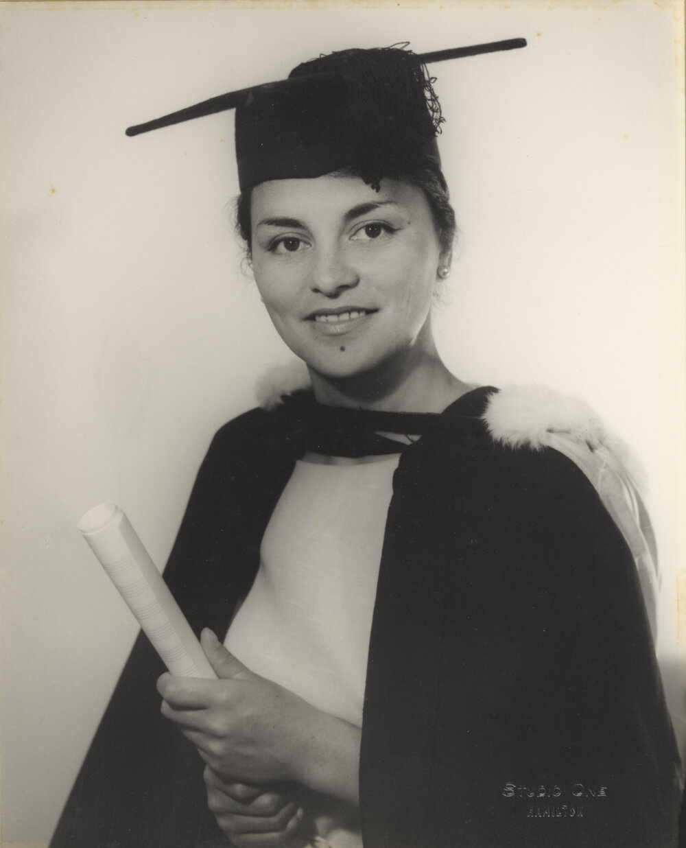 Māori woman graduate in cap and gown