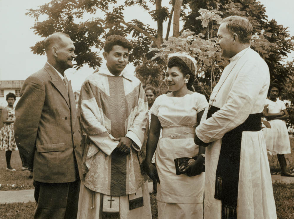Bishop Vockler with a young priest and his parents