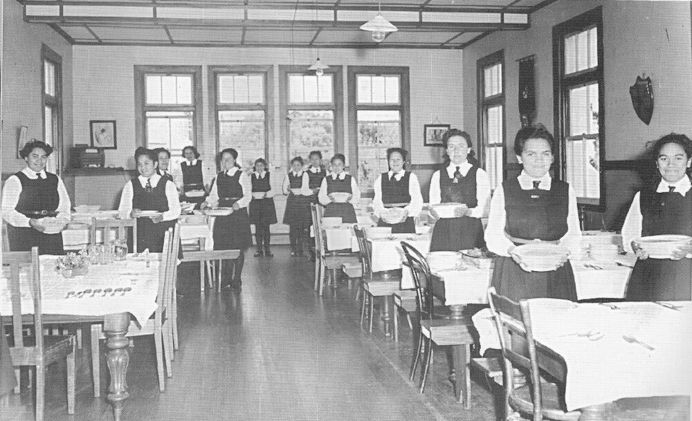 Hukarere students in the dining room standing ready to serve a table