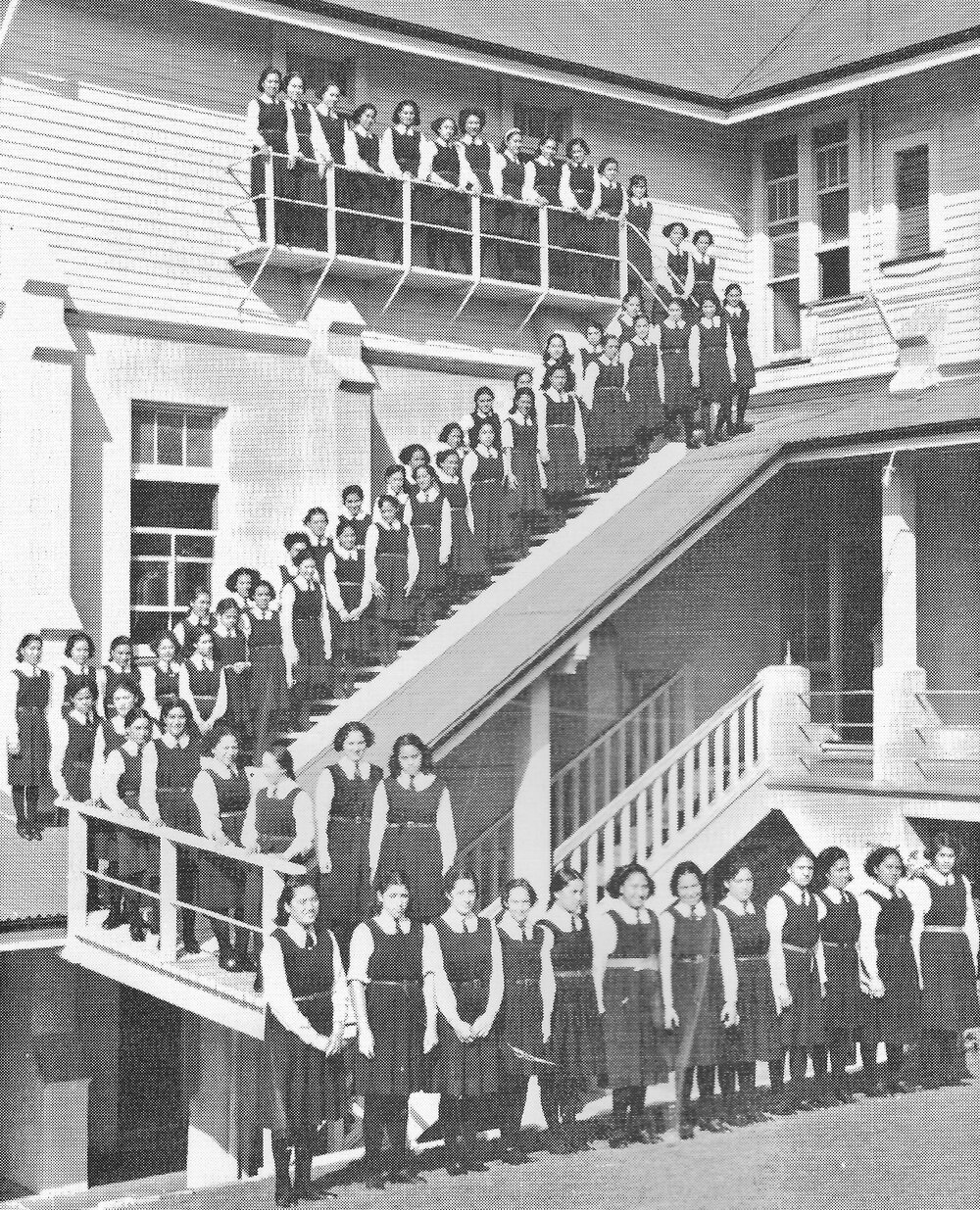 Hukarere School students standing on the balcony and stairs of the wooden school building