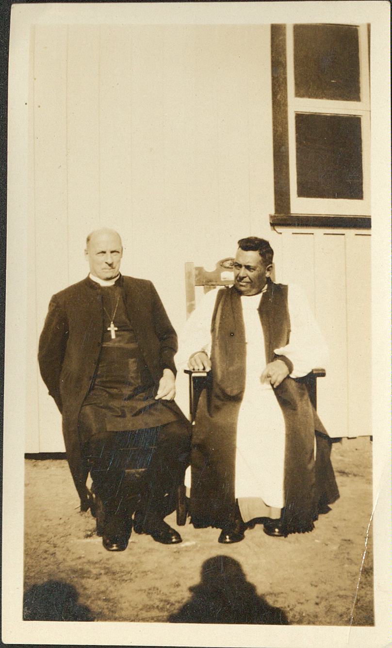 Bishops CA Cherrington (Waikato) and Frederick Bennett (Aotearoa) seated together outside a building