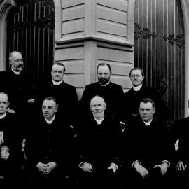 Diocese of Auckland group of clergy photographed outside of a wooden church