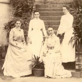 Four European women seated on steps