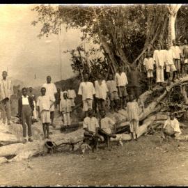 Owo mission, West Africa School boys on timber stack