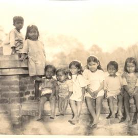 Group of Indian children seated on a wall