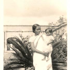 Indian woman holding small child. 