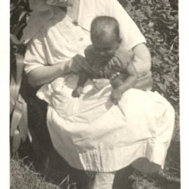 Woman holding a baby. 
