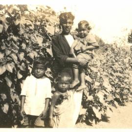 Young man with three young children. 