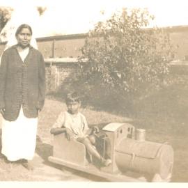 Woman and boy in play train. 