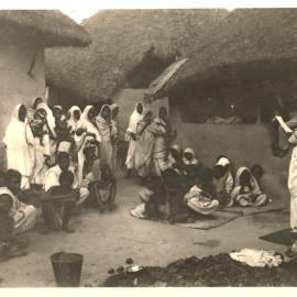 Group of people, listening to a woman. 