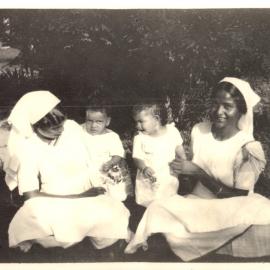 Two women with two small children. 
