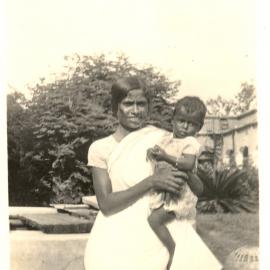 Indian woman holding a small girl. 