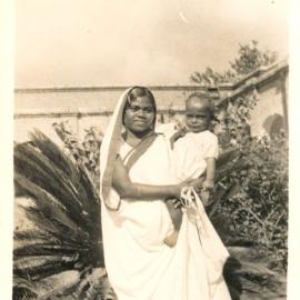 Indian woman holding a small boy. 