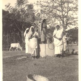 Five women at a well. 