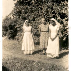 Three women on a oath outside. 
