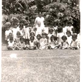 Group of children, and one young woman