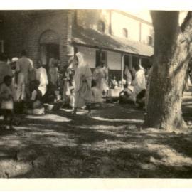 Group of people outside a building. 