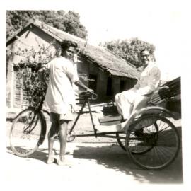Two men on a bike cart. 