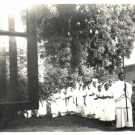 Nurses led by priest