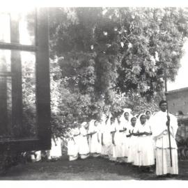 Nurses led by priest
