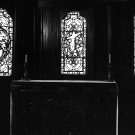 St John's College chapel sanctuary showing the stained glass windows and altar