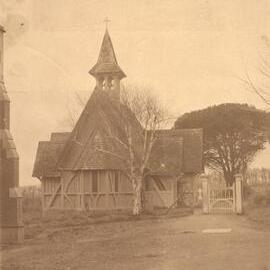 St John's College chapel from the west, showing painted wooden gate, with edge of the Patteson Wing.