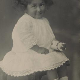 Young child sitting on a tall stool