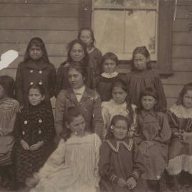 Miss Hall with a group of younger children, labelled 1901 to 1904